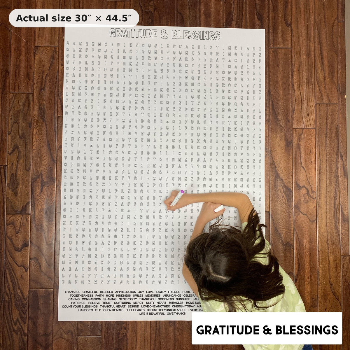 Child doing the Gratitude & Blessings giant word search on the floor, showing its real 30 x 44.5 inch size