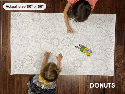 Two kids coloring the Donuts giant coloring sheet on the floor, showing its real 30 x 50 inch size