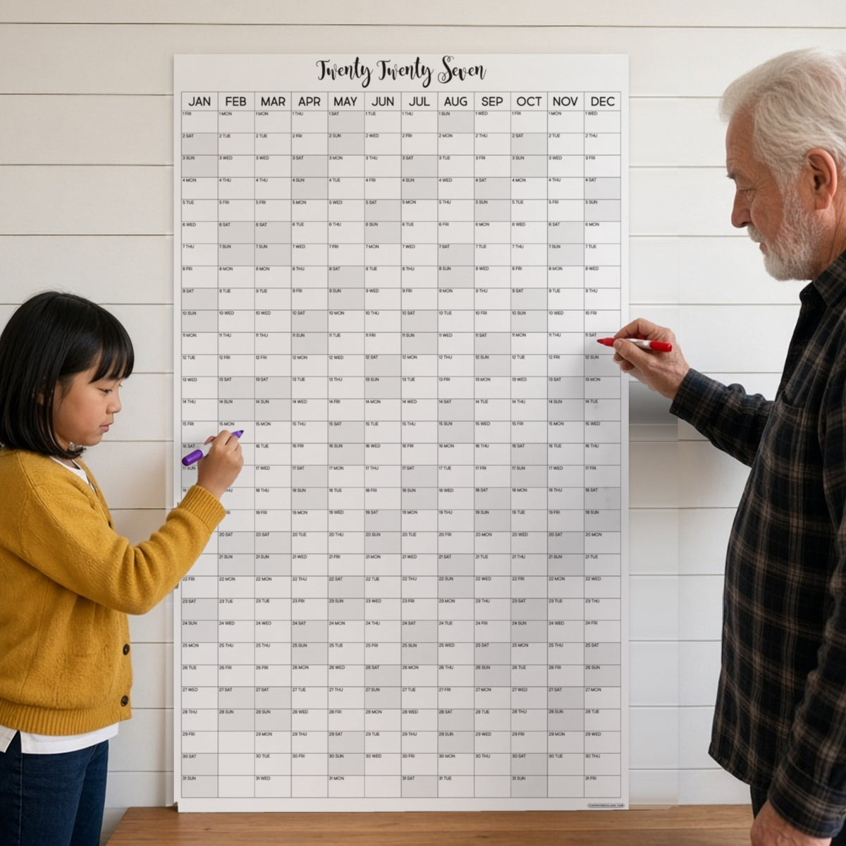 2027 vertical wall calendar on a kitchen wall with grandpa and granddaughter