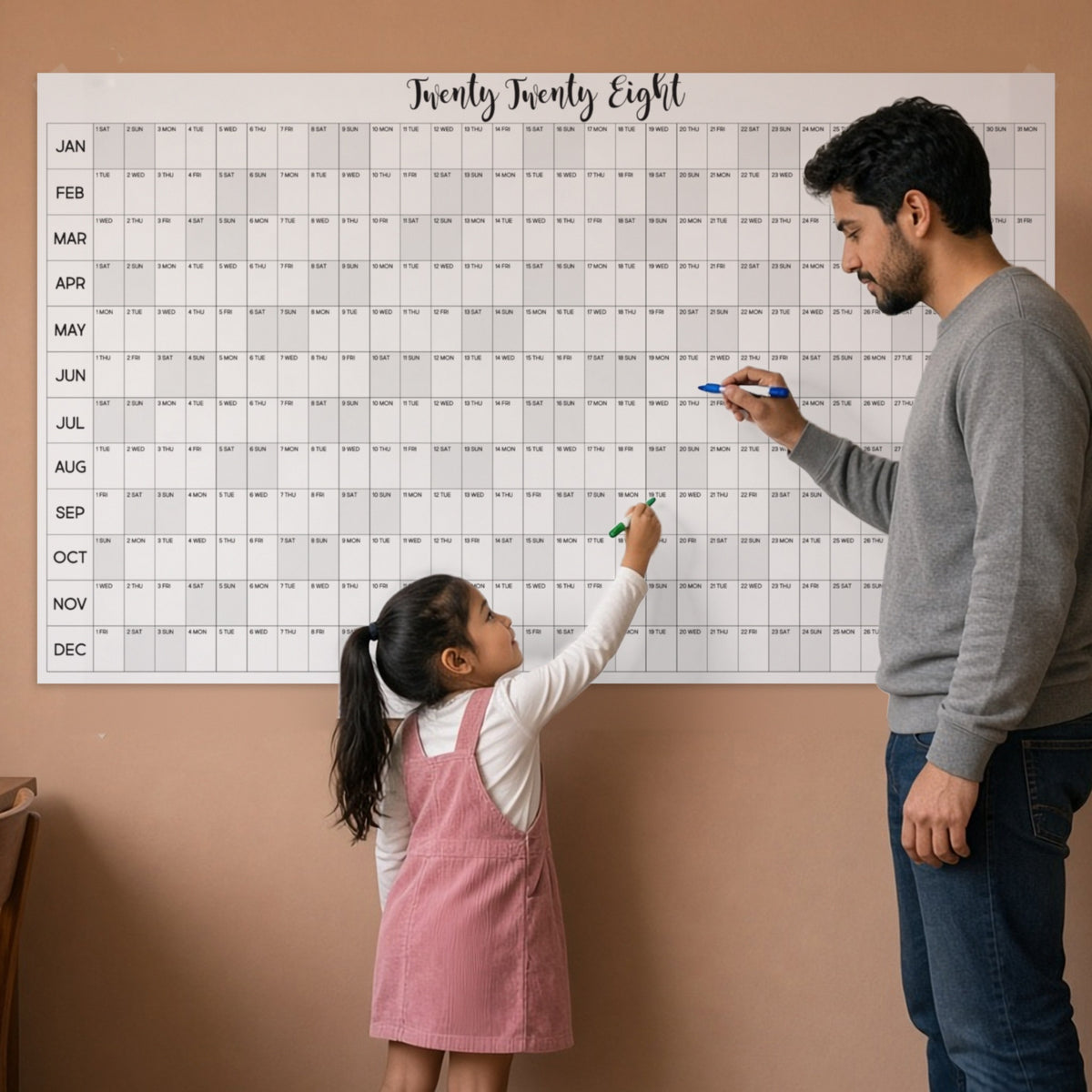2028 horizontal yearly wall calendar in a home office with dad and daughter