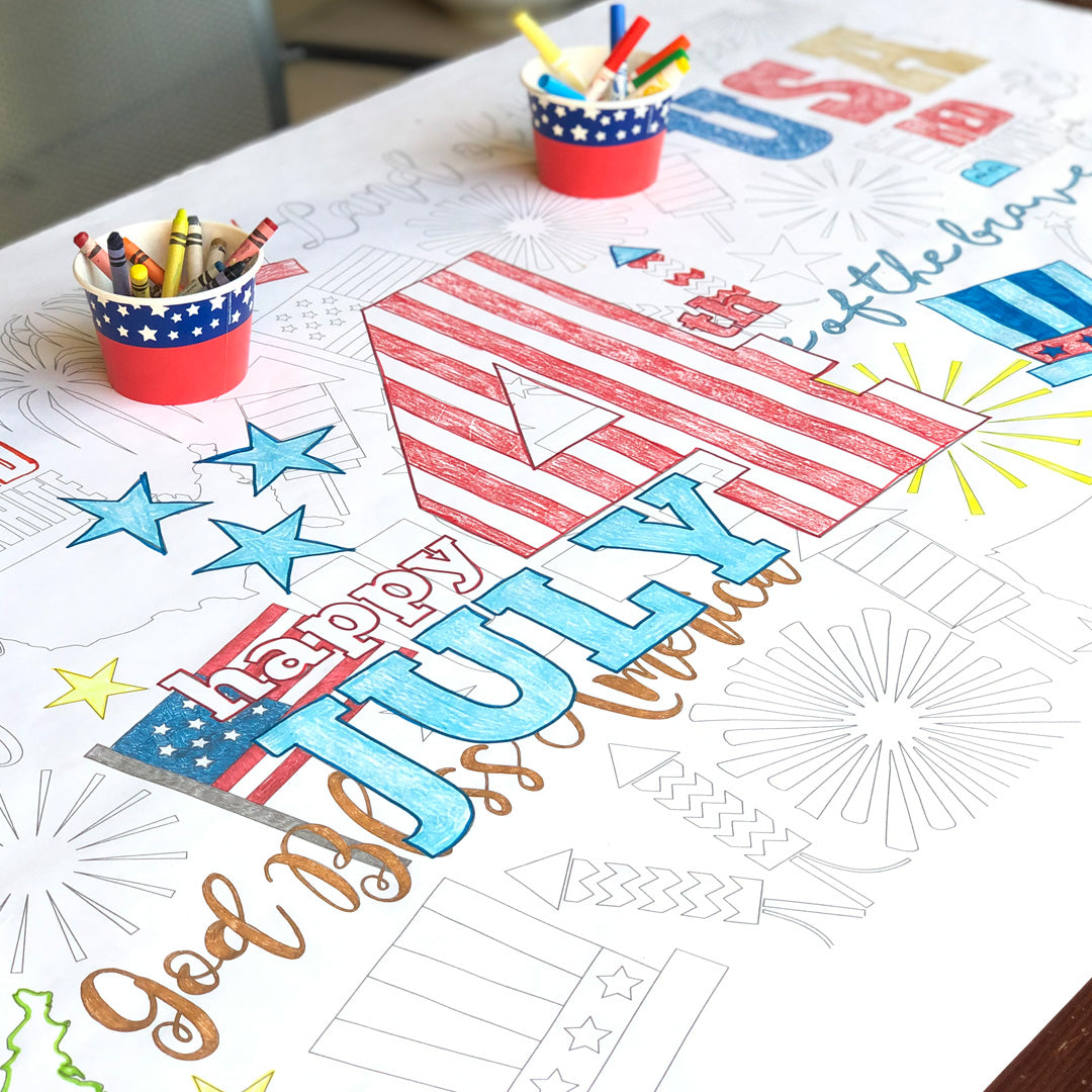 The 4th of July giant coloring sheet being colored in with markers at a table