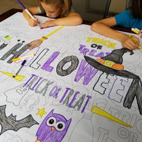 Thumbnail for The Happy Halloween giant coloring sheet being colored in with markers at a table