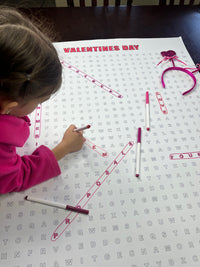 Thumbnail for Kids circling words on the Valentines Day giant word search hung on a wall
