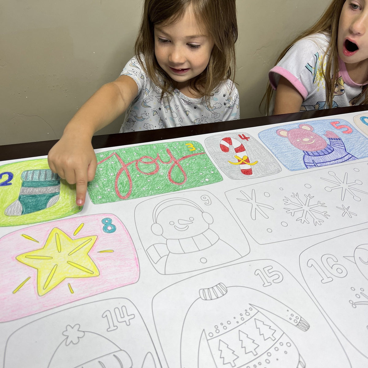 The Advent Merry Christmas Coloring Banner being colored by kids at home
