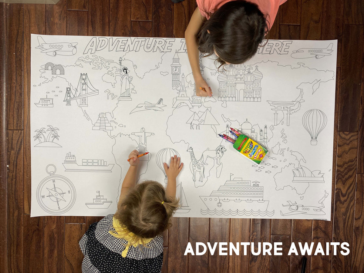 Child coloring the Adventure Awaits giant coloring sheet on a wood floor with crayons