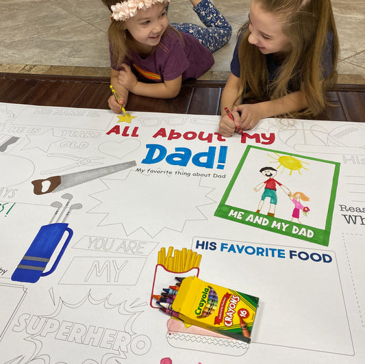 The All About Dad giant coloring sheet being colored in with markers at a table