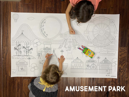 Child coloring the Amusement Park giant coloring sheet on a wood floor with crayons
