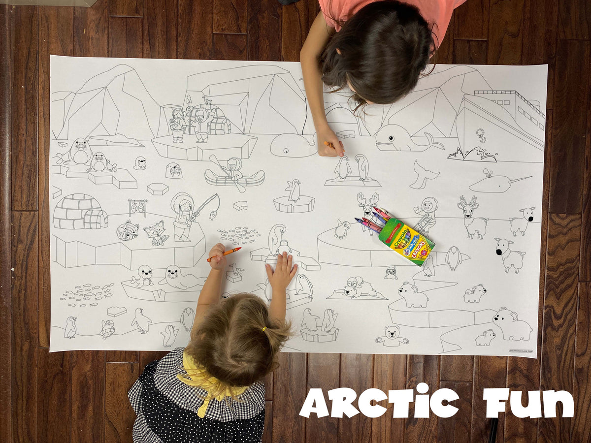 Child coloring the Arctic Fun giant coloring sheet on a wood floor with crayons