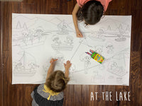 Thumbnail for Child coloring the At the Lake giant coloring sheet on a wood floor with crayons