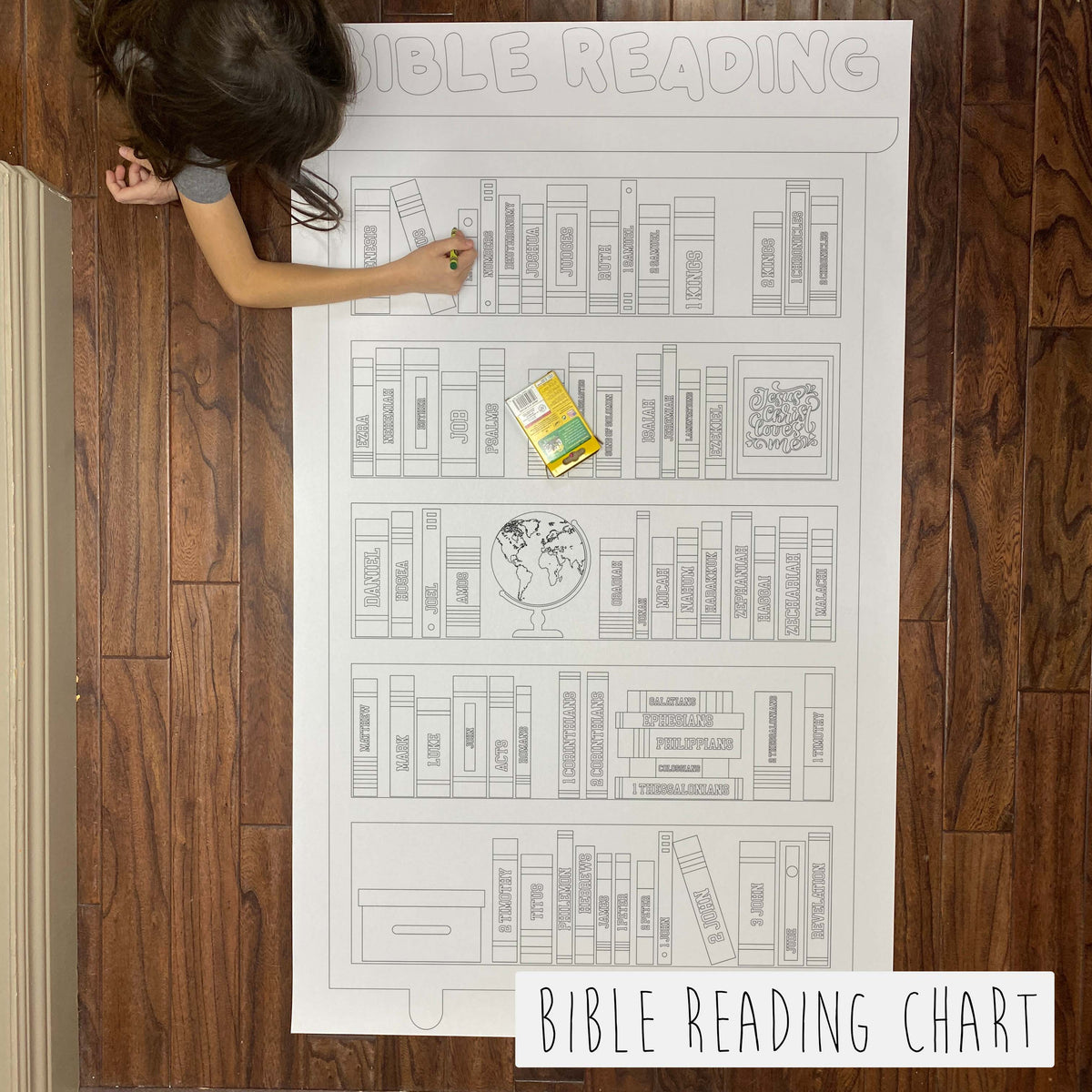 Child coloring the Bible Reading Goal Chart giant coloring sheet on a wood floor with crayons