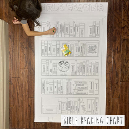 Child coloring the Bible Reading Goal Chart giant coloring sheet on a wood floor with crayons
