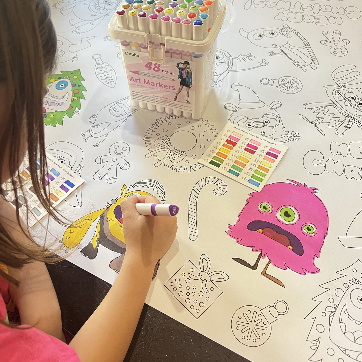 Kids coloring the Christmas Monsters Table Size Coloring Sheet at home
