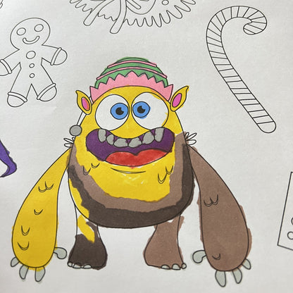The Christmas Monsters Table Size Coloring Sheet being colored by kids at home