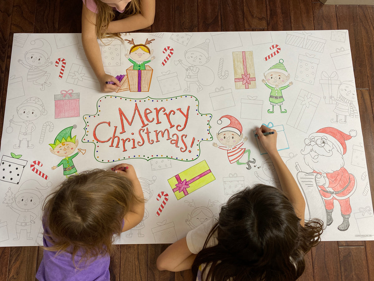 The Elves giant coloring sheet being colored in with markers at a table