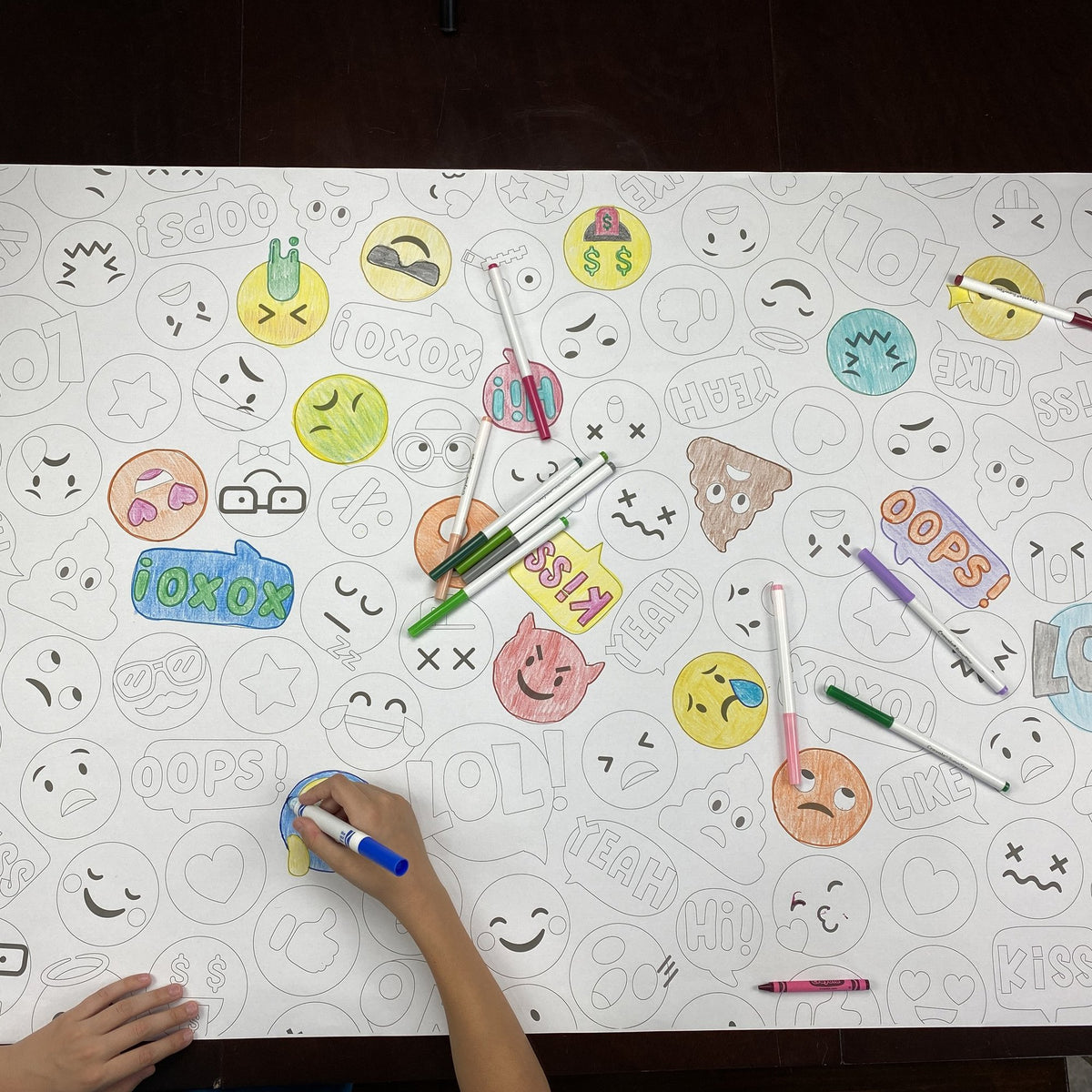 The Emoji Table Size Coloring Sheet being colored by kids at home