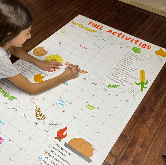 The Fall Activity Calendar giant coloring sheet being colored in with markers at a table