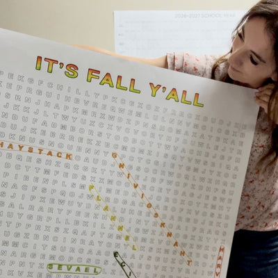 Girl holding up the finished It's Fall Y'all giant word search