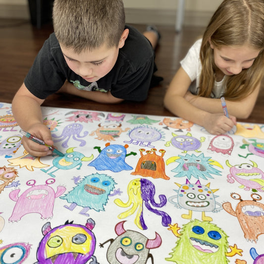 Kids coloring the Monsters Table Size Coloring Sheet at home