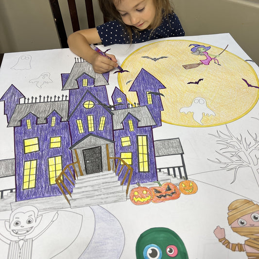 Kids coloring the Halloween Night Table Size Coloring Sheet at home