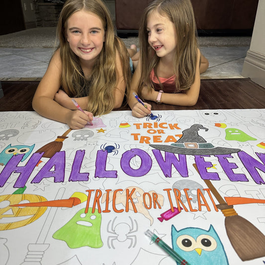 Kids coloring the Happy Halloween Table Size Coloring Sheet at home