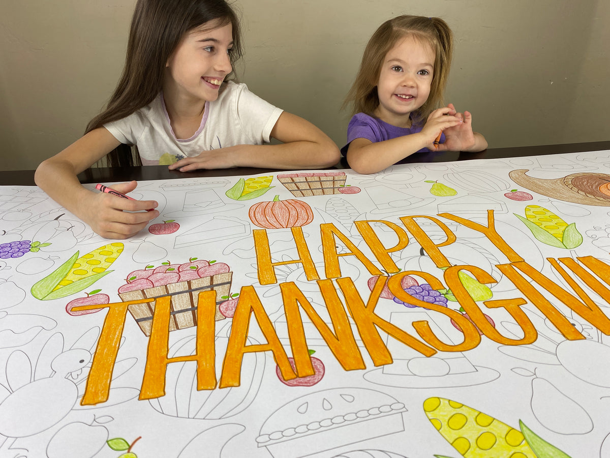 The Happy Thanksgiving giant coloring sheet being colored in with markers at a table