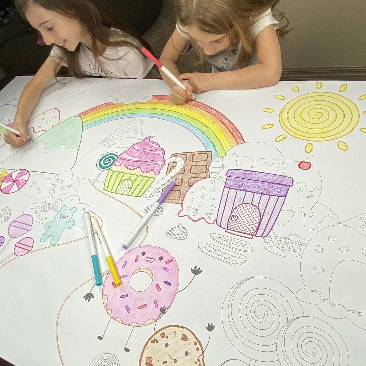 Kids coloring the I Spy Candyland Table Top Coloring Banner at home