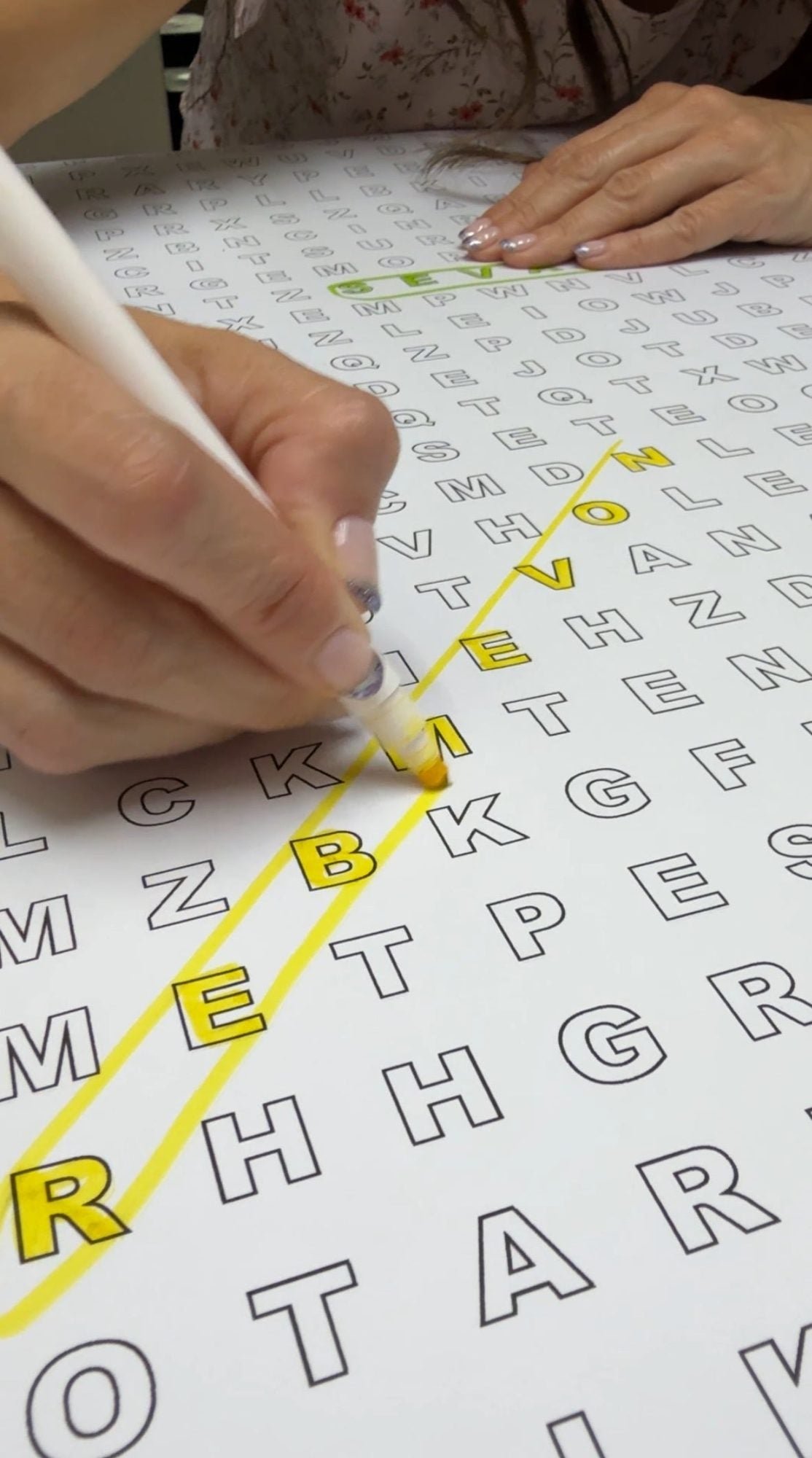 Close-up of the It's Fall Y'all giant word search with found words circled in color