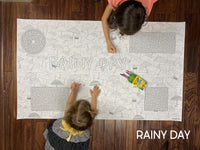 Thumbnail for Child coloring the Rainy Day giant coloring sheet on a wood floor with crayons