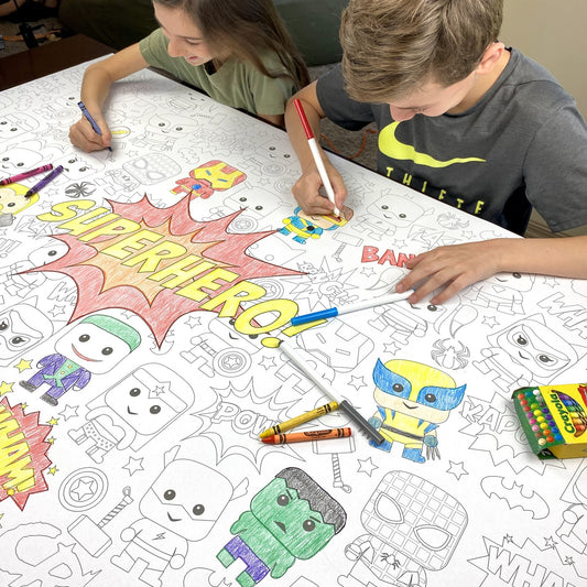 Kids coloring the Superhero Table Size Coloring Sheet at home
