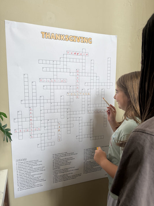 Kids solving the Thanksgiving Giant Crossword Puzzle, a giant 30x44.5 inch sheet hung on the wall