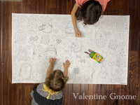 Thumbnail for Child coloring the Valentine Gnome giant coloring sheet on a wood floor with crayons