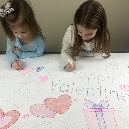Kids coloring the Valentines Trace & Color Coloring Sheet at home