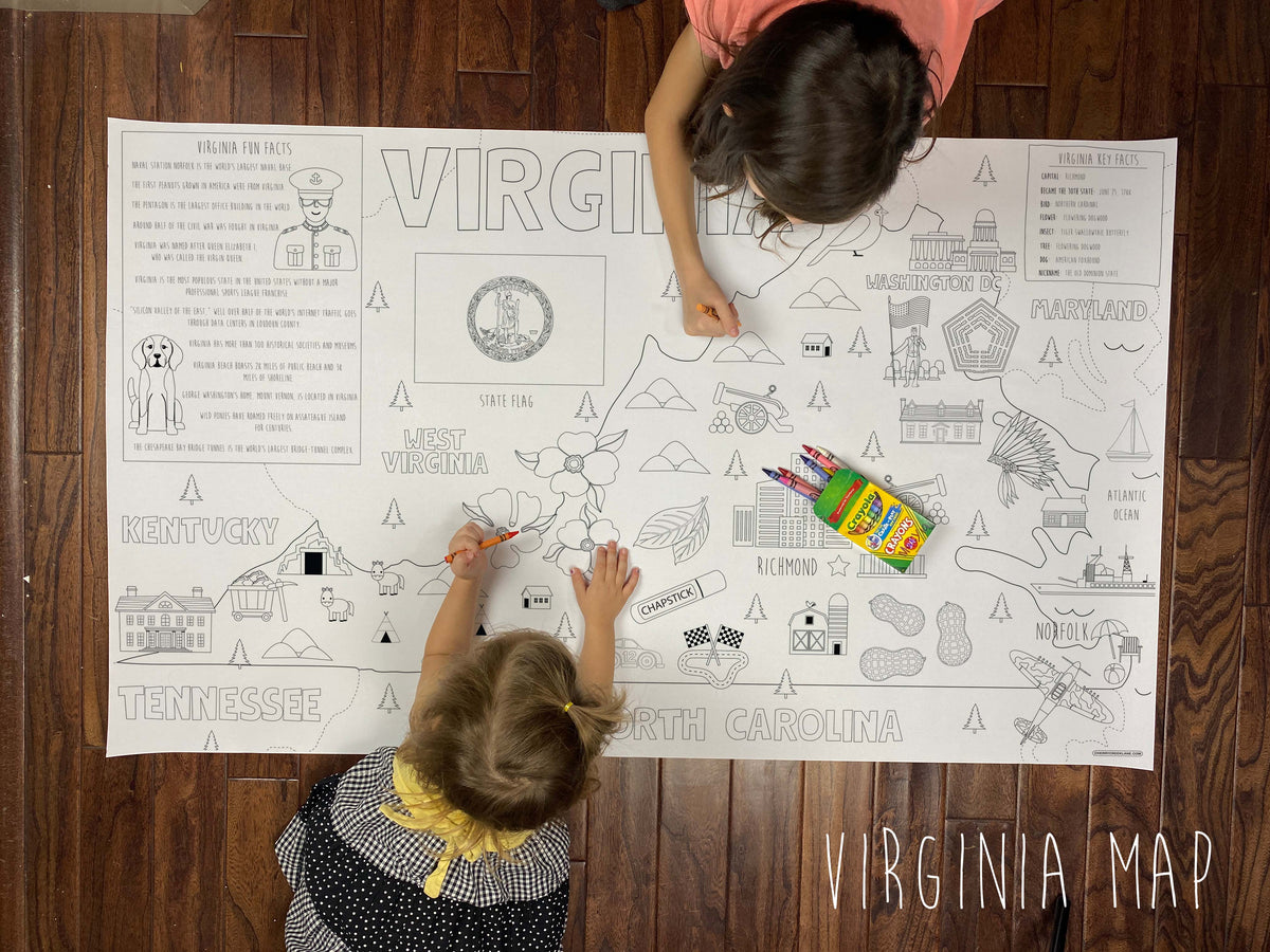 Child coloring the Virginia state giant coloring map on a wood floor