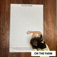 Thumbnail for Child solving the On The Farm giant word search poster on a wood floor