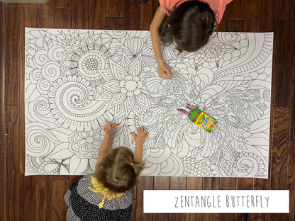 Child coloring the Zentangle Butterfly giant coloring sheet on a wood floor with crayons