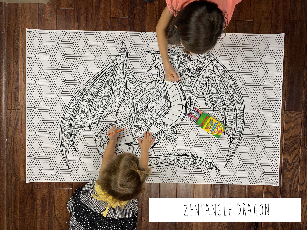 Child coloring the Zentangle Dragon giant coloring sheet on a wood floor with crayons