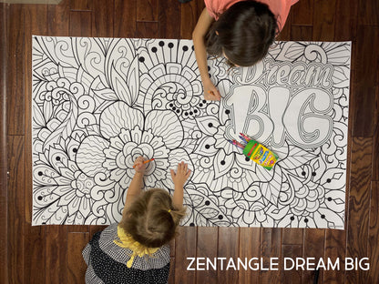 Child coloring the Zentangle Dream Big giant coloring sheet on a wood floor with crayons