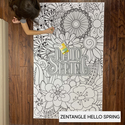 Child coloring the Zentangle Hello Spring giant coloring sheet on a wood floor with crayons