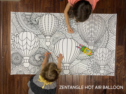 Child coloring the Zentangle Hot Air Balloon giant coloring sheet on a wood floor with crayons