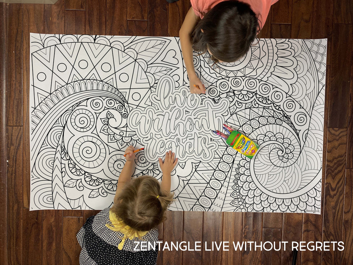 Child coloring the Zentangle Live Without Regrets giant coloring sheet on a wood floor with crayons