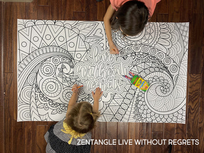 Child coloring the Zentangle Live Without Regrets giant coloring sheet on a wood floor with crayons