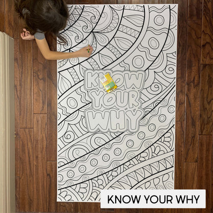 Child coloring the Zentangle Know Your Why giant coloring sheet on a wood floor with crayons