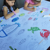 Thumbnail for The Under the Sea giant coloring sheet being colored in with markers at a table