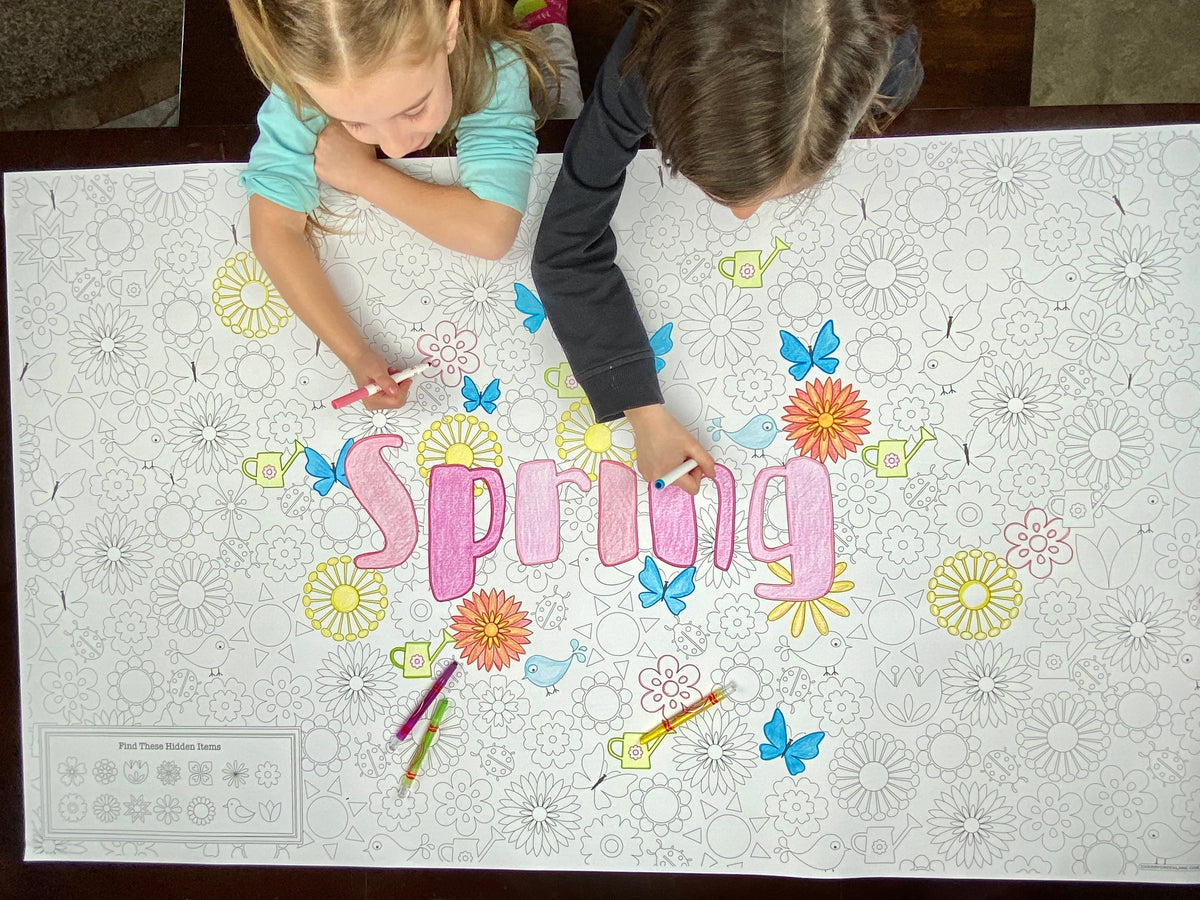 The Spring giant coloring sheet being colored in with markers at a table