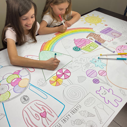 A candy themed giant coloring sheet being colored in with markers at a table
