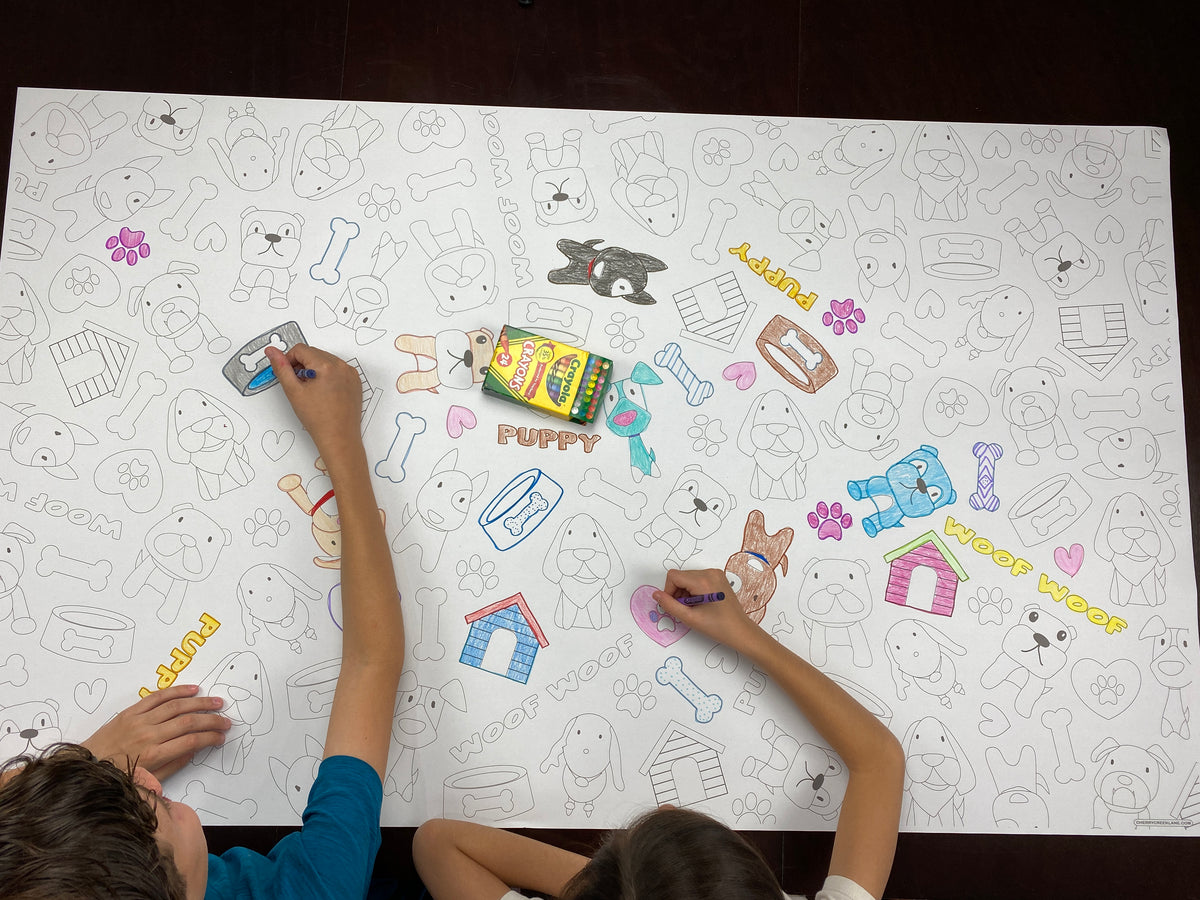 The Puppy giant coloring sheet being colored in with markers at a table