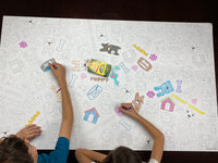 Thumbnail for The Puppy giant coloring sheet being colored in with markers at a table