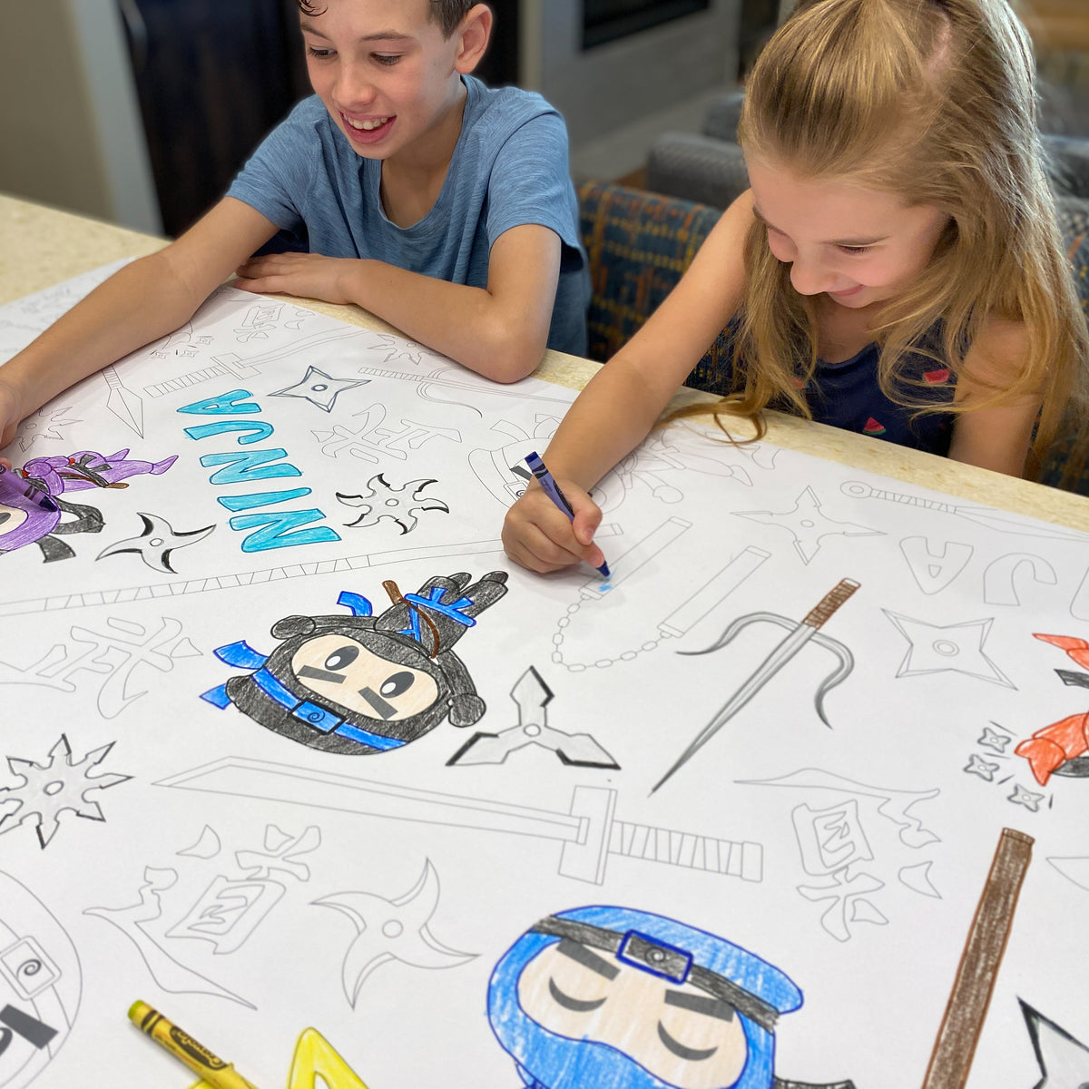 The Ninja Warrior giant coloring sheet being colored in with markers at a table