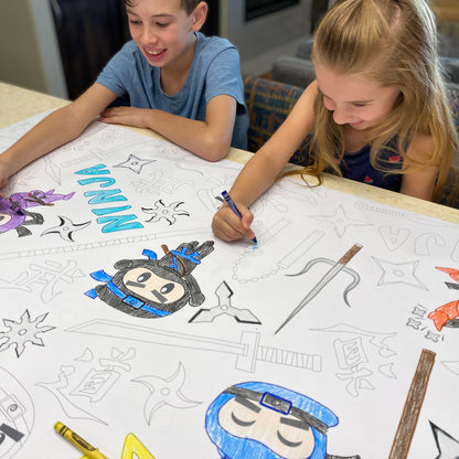 The Ninja Warrior giant coloring sheet being colored in with markers at a table
