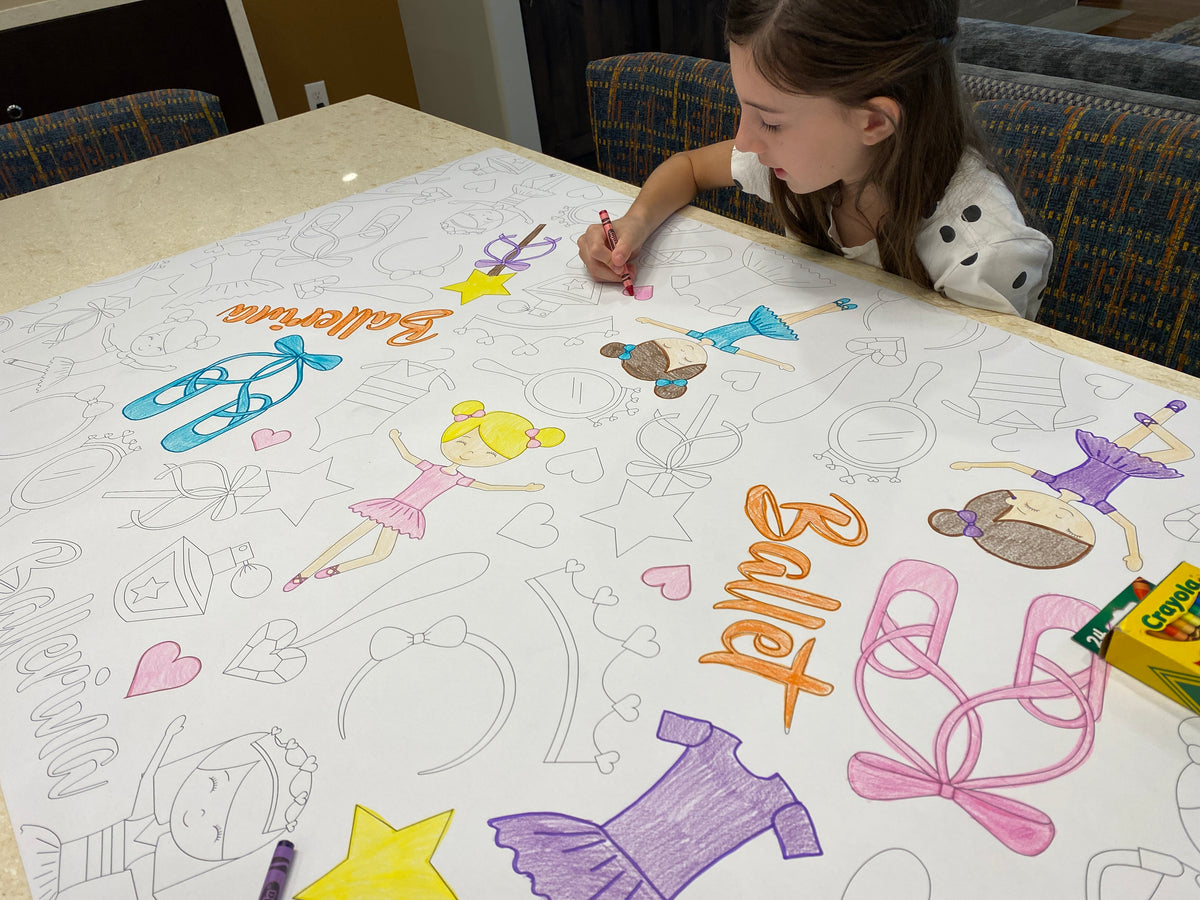 The Ballet giant coloring sheet being colored in with markers at a table